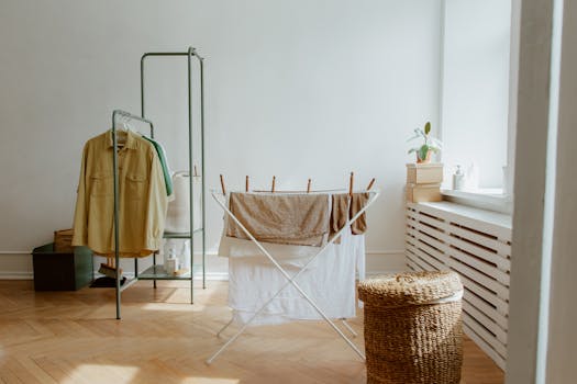 A laundry room with natural light and organized clothes drying setup.